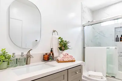 a bathroom with a sink and a mirror at Luxury House 3-Level 4-bedroom, Free Parking and Patio in Los Angeles