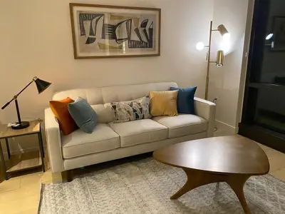 a living room with a couch and a table at Luxury 1 Bedroom vacation Home in Downtown LA in Los Angeles