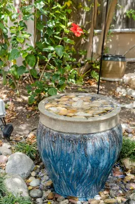 a large blue vase sitting on the ground at Venice Beach Cottage Retreat in Los Angeles