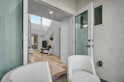 two white chairs in a room with a hallway at Modern 1-Bedromm Loft In Hollywood With Viwe of Hollywood Sign in Los Angeles