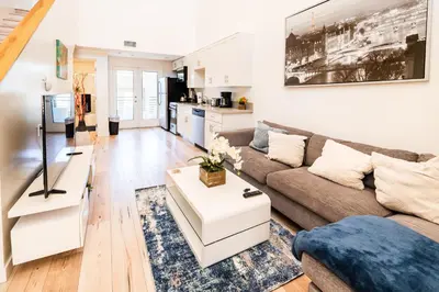 a living room with a couch and a table at Modern 1-Bedromm Loft In Hollywood With Viwe of Hollywood Sign in Los Angeles