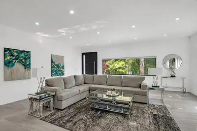 a large white living room with a couch and tables at Mansfield Modern in Los Angeles