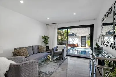 a living room with a couch and a swimming pool at Mansfield Modern in Los Angeles