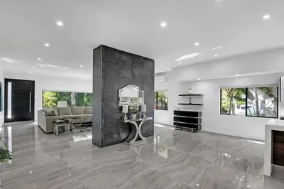 a large living room with a couch and a mirror at Mansfield Modern in Los Angeles