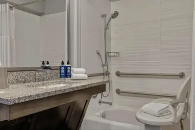 a bathroom with a sink and a toilet and a tub at Dolphin's Cove in Anaheim