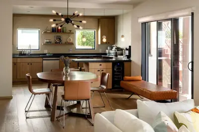 a kitchen and living room with a table and chairs at NEW! High-End Spanish Duplex | Luxury 3BR in Los Angeles