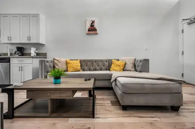 a living room with a couch and a table at Loft-Style 1-Bedroom Apartment with Balcony & Private Parking in Hollywood in Los Angeles