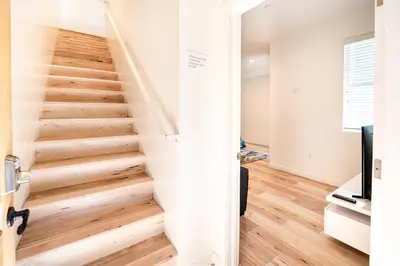 a staircase in a home with wooden floors at Chic Hollywood Koreatown 3Bedroom Loft 3 Level 2 Bathrooms Perfect for Groups up to 10 in Los Angeles