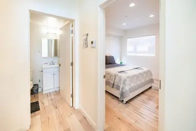 a bedroom with a bed and a bathroom at Chic Hollywood Koreatown 3Bedroom Loft 3 Level 2 Bathrooms Perfect for Groups up to 10 in Los Angeles