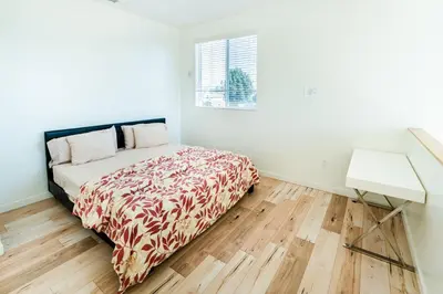 a white bedroom with a bed and a desk at Chic Hollywood Koreatown 3Bedroom Loft 3 Level 2 Bathrooms Perfect for Groups up to 10 in Los Angeles