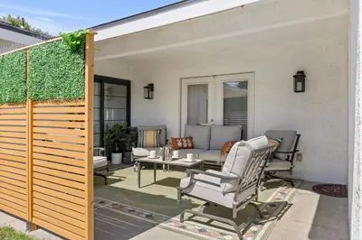 a patio with chairs and a table and a fence at KingBeds Skylight 1GB Wi-Fi Step-free Clean in Bakersfield