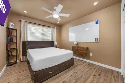 a bedroom with a bed and a projection screen at KingBeds Skylight 1GB Wi-Fi Step-free Clean in Bakersfield