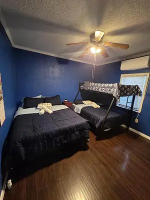 a bedroom with two beds and a ceiling fan at Entire Front House in Los Angeles in Los Angeles