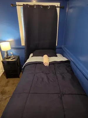 a bed with a black head board in a room at Entire Front House in Los Angeles in Los Angeles