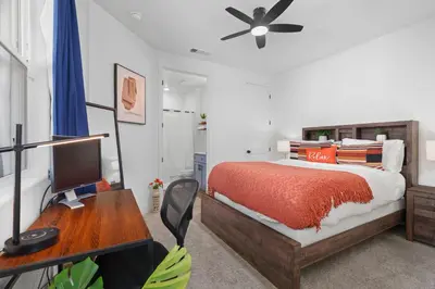 a bedroom with a bed and a desk with a computer at Modern 1BR Suite w AC Sleeps 3, NW Bakersfield in Bakersfield