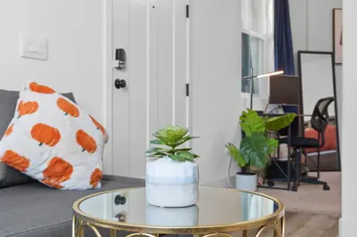 a living room with a table with a vase on it at Modern 1BR Suite w AC Sleeps 3, NW Bakersfield in Bakersfield