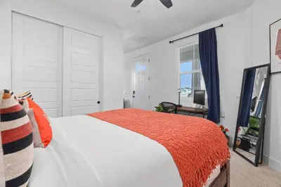 a white bedroom with a bed and a mirror at Modern 1BR Suite w AC Sleeps 3, NW Bakersfield in Bakersfield