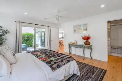 a bedroom with a bed and a table at Spacious 4BR Games Workspace Outdoor Fun in Los Angeles