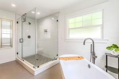 a white bathroom with a shower and a tub at Spacious 4BR Games Workspace Outdoor Fun in Los Angeles