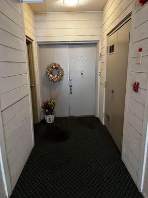 a hallway with a door with a wreath on it at 1140 Alta Loma in Los Angeles