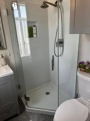 a bathroom with a shower and a toilet at 1140 Alta Loma in Los Angeles