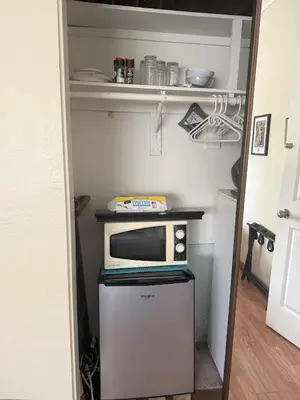 a microwave oven sitting on top of a refrigerator at 1140 Alta Loma in Los Angeles