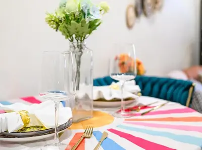 a table with plates and glasses and a vase with flowers at \u8fd1ONT\u673a\u573aChaffeyClaremont \u5b66\u9662Outlets1B1B in Rancho Cucamonga