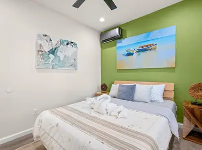 a bedroom with a white dog laying on a bed at \u8fd1ONT\u673a\u573aChaffeyClaremont \u5b66\u9662Outlets1B1B in Rancho Cucamonga