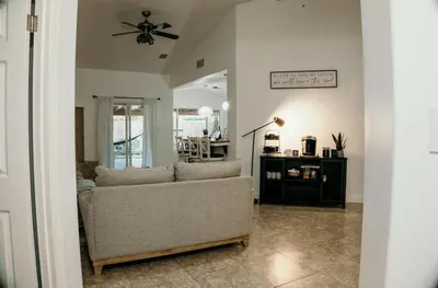 a living room with a couch and a ceiling fan at Stunning Home with Pool, Game Room and Firepit in Bakersfield