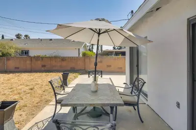 a table and chairs with an umbrella on a patio at HOV Lux Whitehouse Lakeview Terrace