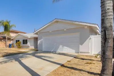 a garage in a house with a palm tree at HOV Lux Whitehouse Lakeview Terrace