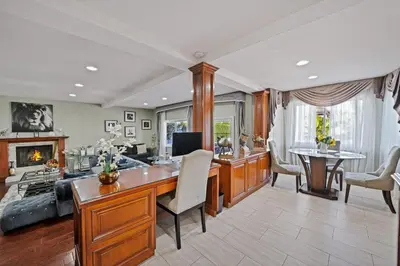 a home office with a desk and a fireplace at Gorgeous Villa with Private Heated Pool in Garnsey