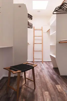 a room with a table and a ladder and shelves at Mid-Century Modern Hillside Escape With Dome and Views in Los Angeles
