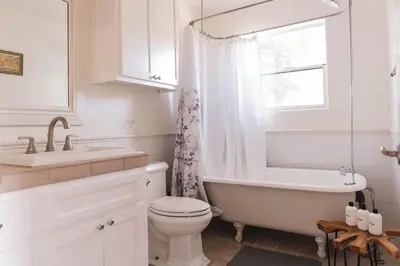 a bathroom with a tub and a toilet and a sink at Mid-Century Modern Hillside Escape With Dome and Views in Los Angeles