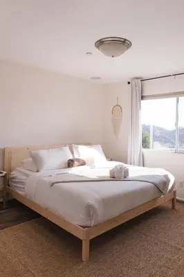 a large bed in a bedroom with a window at Mid-Century Modern Hillside Escape With Dome and Views in Los Angeles