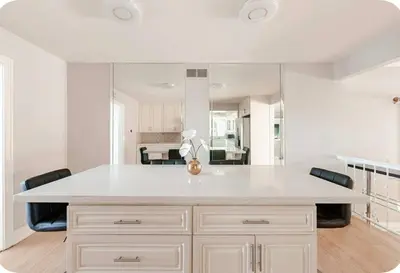 a kitchen with a large white island with black chairs at Spacious and Exclusive Oasis 6BR 3BA in Thousand Oaks
