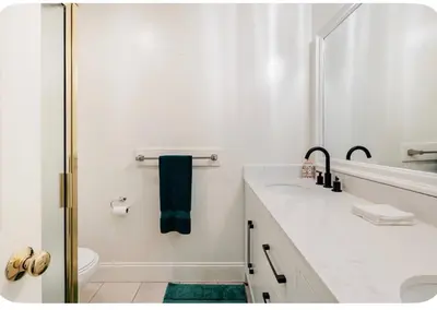 a white bathroom with a sink and a shower at Spacious and Exclusive Oasis 6BR 3BA in Thousand Oaks