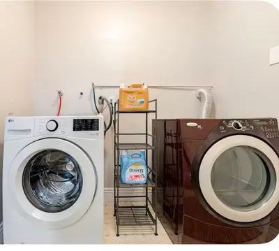 a laundry room with a washing machine and a shelf at Spacious and Exclusive Oasis 6BR 3BA in Thousand Oaks
