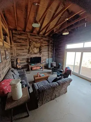 a living room with a couch and a table at Mountain Top Barn retreat with View in Bodfish