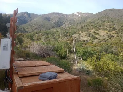 a wooden deck with a view of a mountain at Mountain Top Barn retreat with View in Bodfish