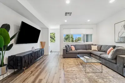 a living room with a couch and a tv at NoHo Modern Townhouse with Gorgeous Rooftop in Van Nuys