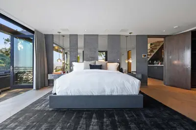 a bedroom with a large bed and a large window at White Lotus by Stay Awhile Villas in Los Angeles