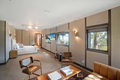 a living room with a bed and a table and chairs at White Lotus by Stay Awhile Villas in Los Angeles
