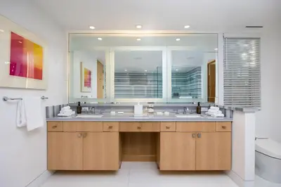 a bathroom with a sink and a large mirror at Casa Mare by Stay Awhile Villas in Malibu Beach