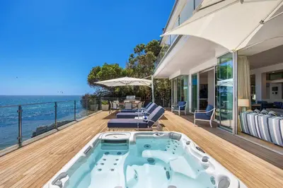 a hot tub on the deck of a house at Casa Mare by Stay Awhile Villas in Malibu Beach
