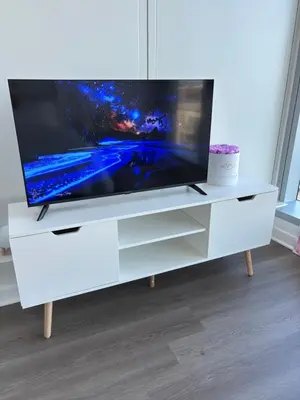 a white entertainment center with a flat screen tv on it at Aqua Marina Oceanfront Escape in Long Beach