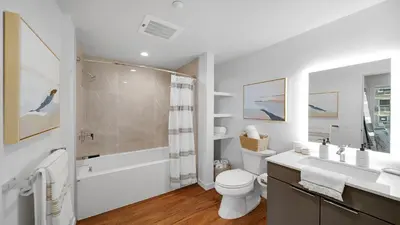 a bathroom with a toilet and a sink and a shower at Aqua Marina Oceanfront Escape in Long Beach
