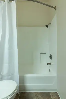 a bathroom with a white tub and a toilet at Marvelous 2BR 2BA Apartment in Los Angeles