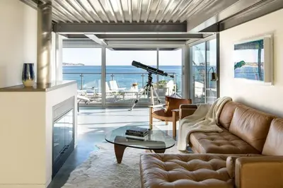 a living room with a couch and a table at Broad Beach Wdirect Beach Access in Malibu