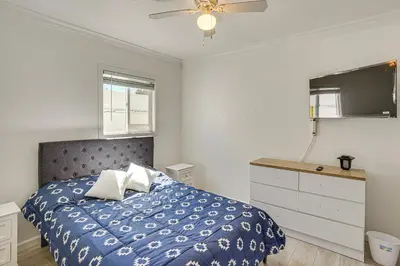 a bedroom with a blue bed and a dresser at Between LA and Orange County Quiet Getaway with Patio in Pico Rivera